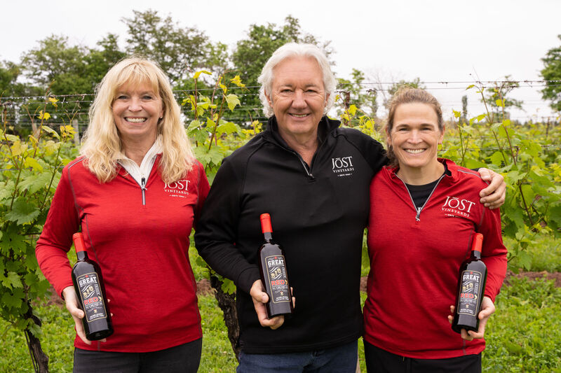 Owners Donna and Carl Sparkes with Head Winemaker, Gina Haverstock in the vineyard with bottles of Great Big Friggin' Red wine.