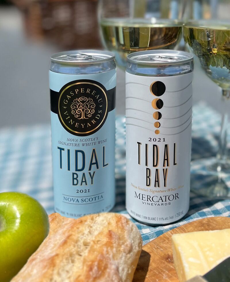 Gaspereau and Mercator Tidal Bay in 250ml can format with bread, apple and wine glasses