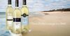 Three bottles of Tidal Bay wine on the beach